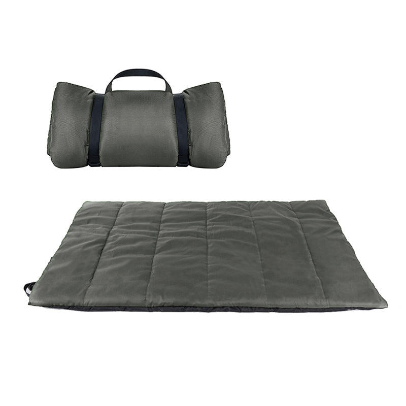 The Artemis Travel Bed in grey, rolled with carry handle