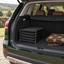 Folded dog car stairs stored neatly in the boot of a green SUV